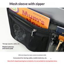 Black mesh sleeve with zipper containing a book titled 'Mum's News' on a white background.