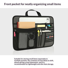 Black front pocket organizer with various items on a white background