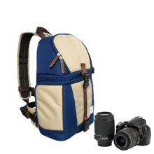 Blue and beige backpack with camera and lenses on a white background