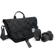 Black camera bag with a camera and lens on a white background