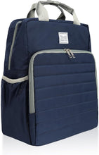 A navy blue diaper backpack with light gray accents, including the top handles, zipper trims, and a side mesh pocket. The front features a large horizontal zippered compartment with a quilted texture, and a small white brand label is visible near the top center.