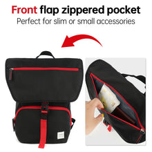 Black backpack with red zippers and front flap zipper pocket feature, showing a phone inside.